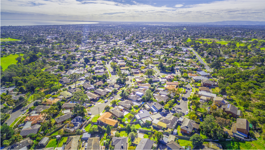 Aerial panorama of town houses near ocean bay on bright sunny day